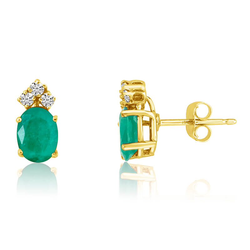These 6x4 mm oval shaped emerald earrings are set in beautiful 14k yellow gold and feature .12 total carat diamonds.