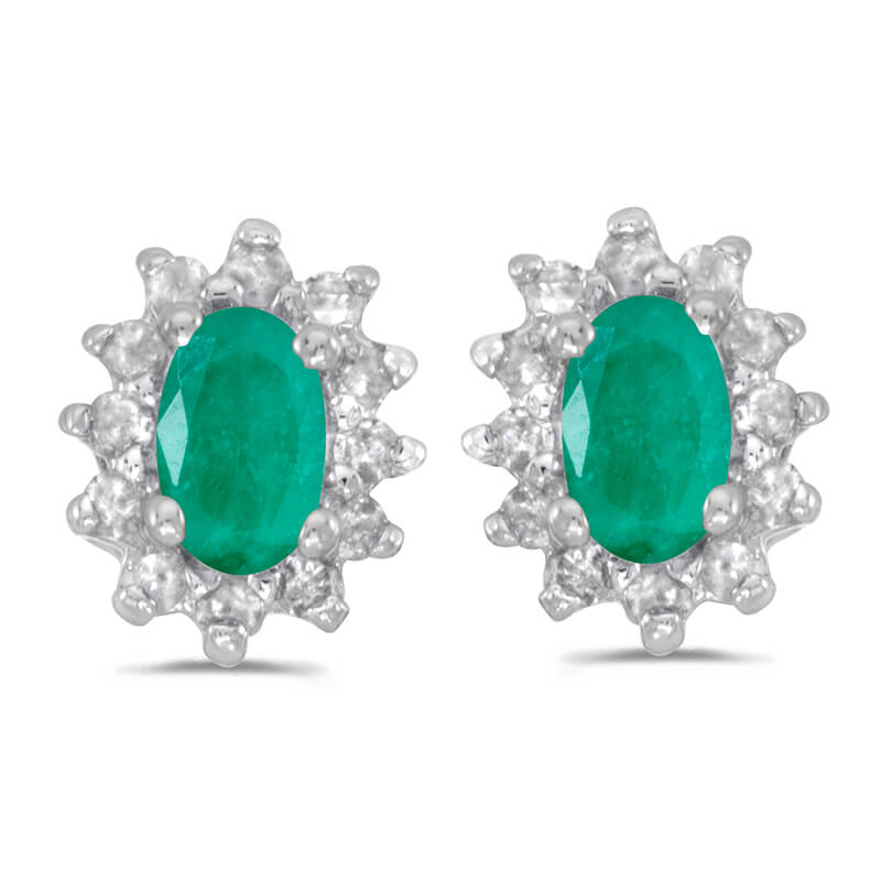 These 14k white gold oval emerald and .25 ct diamond earrings feature 5x3 mm genuine natural emeralds with a 0.32 ct total weight.