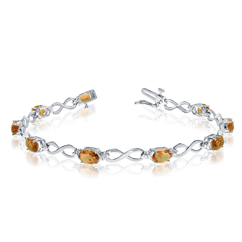 JCX3104: This 10k white gold oval citrine and diamond bracelet features nine 6x4 mm stunning natural citrine stones with a 2.79 ct total gem weight.
