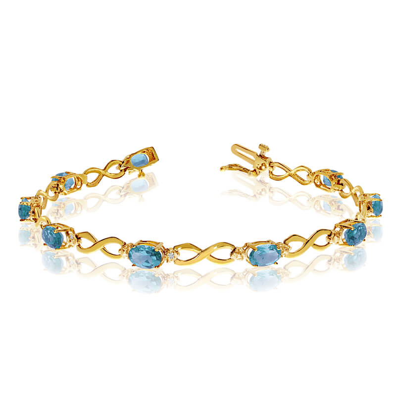 This 14k yellow gold oval blue topaz and diamond bracelet features nine 6x4 mm stunning natural blue topaz stones with a 3.60 ct total gem weight.