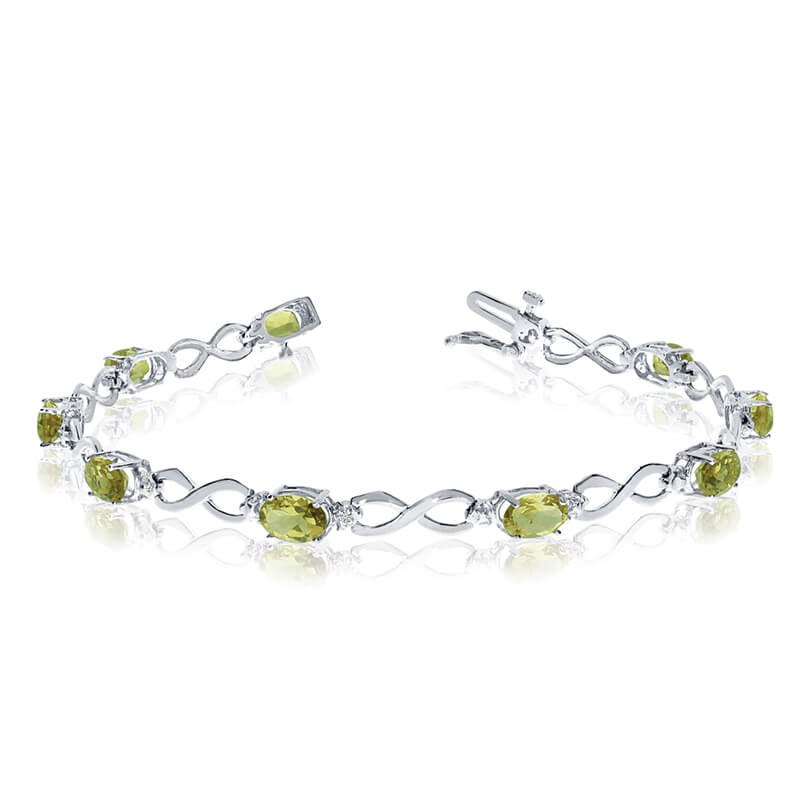 JCX3123: This 14k white gold oval peridot and diamond bracelet features nine 6x4 mm stunning natural peridot stones with a 3.60 ct total gem weight.