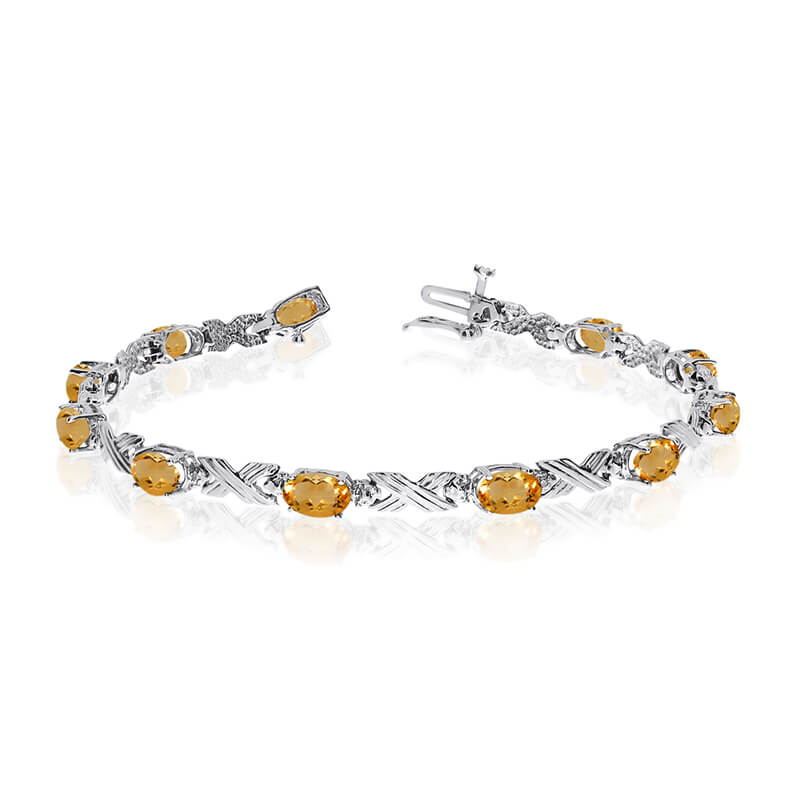 JCX3169: This 14k white gold oval citrine and diamond bracelet features eleven 6x4 mm stunning natural citrine stones with a 3.41 ct total gem weight.