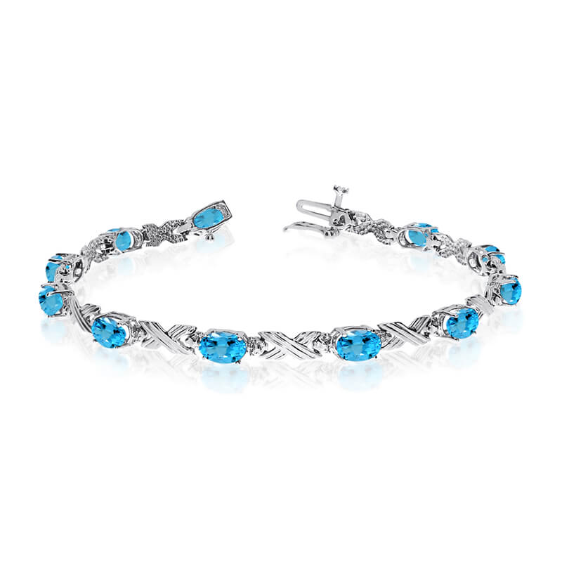 This 14k white gold oval blue topaz and diamond bracelet features eleven 6x4 mm stunning natural blue topaz stones with a 4.40 ct total gem weight.
