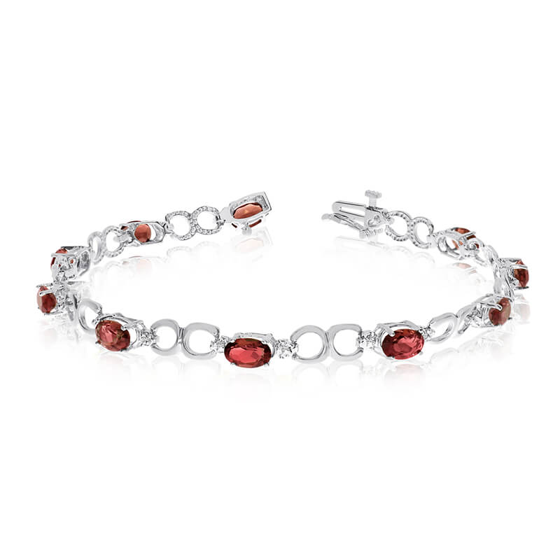 This 10k white gold oval garnet and diamond bracelet features ten 6x4 mm stunning natural garnet stones with a 4.70 ct total gem weight.