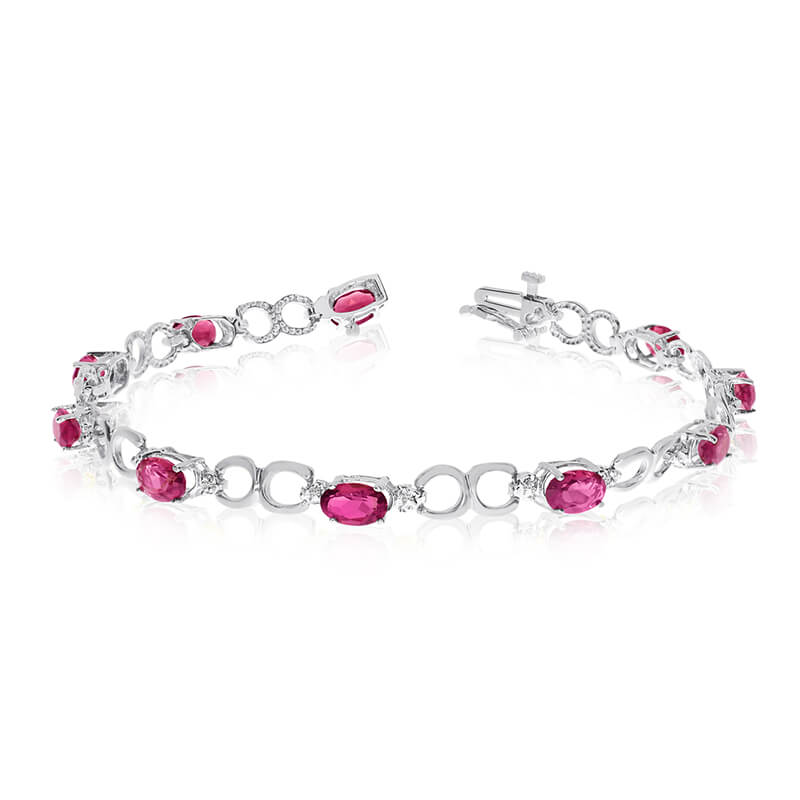 This 10k white gold oval ruby and diamond bracelet features ten 6x4 mm stunning natural ruby stones with 3.60 ct total gem weight.