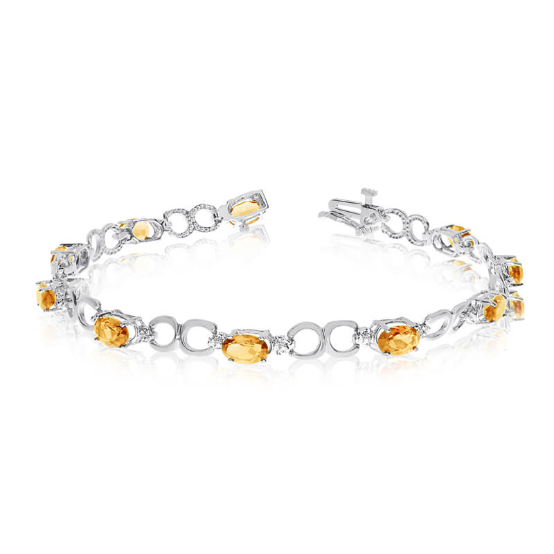 JCX3219: This 10k white gold oval citrine and diamond bracelet features ten 6x4 mm stunning natural citrine stones with a 3.10 ct total gem weight.