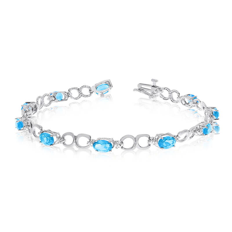 JCX3220: This 10k white gold oval blue topaz and diamond bracelet features ten 6x4 mm stunning natural blue topaz stones with a 4.00 ct total gem weight.