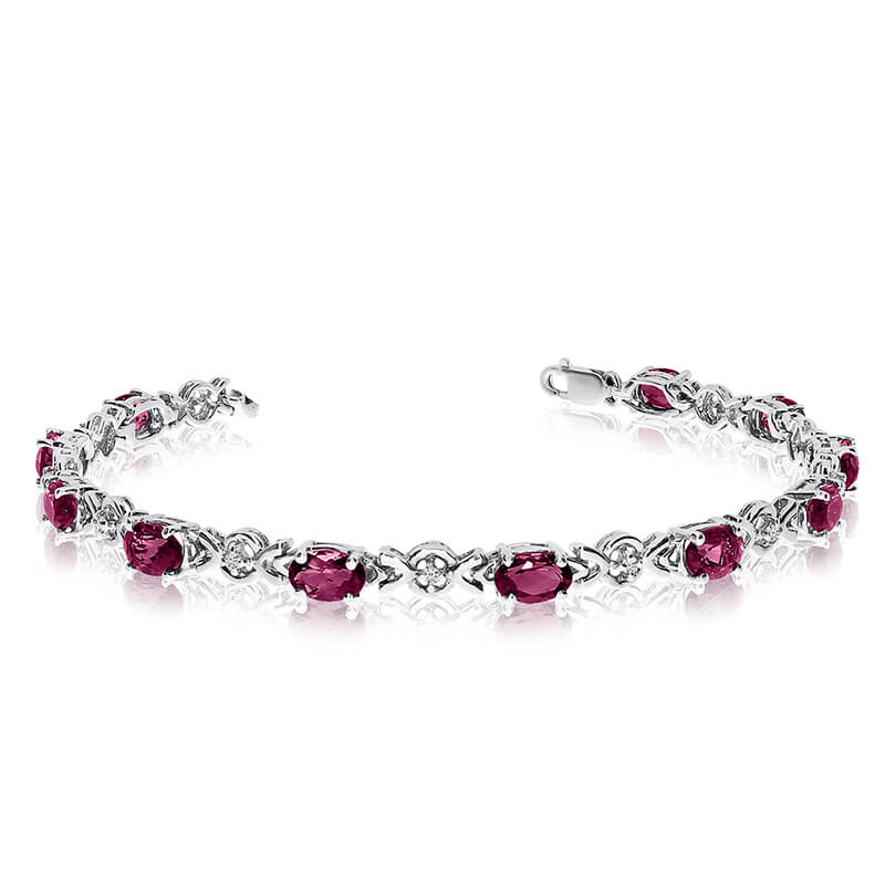 This 10k white gold oval ruby and diamond bracelet features eleven 6x4 mm stunning natural ruby stones with a 3.96 ct total gem weight.
