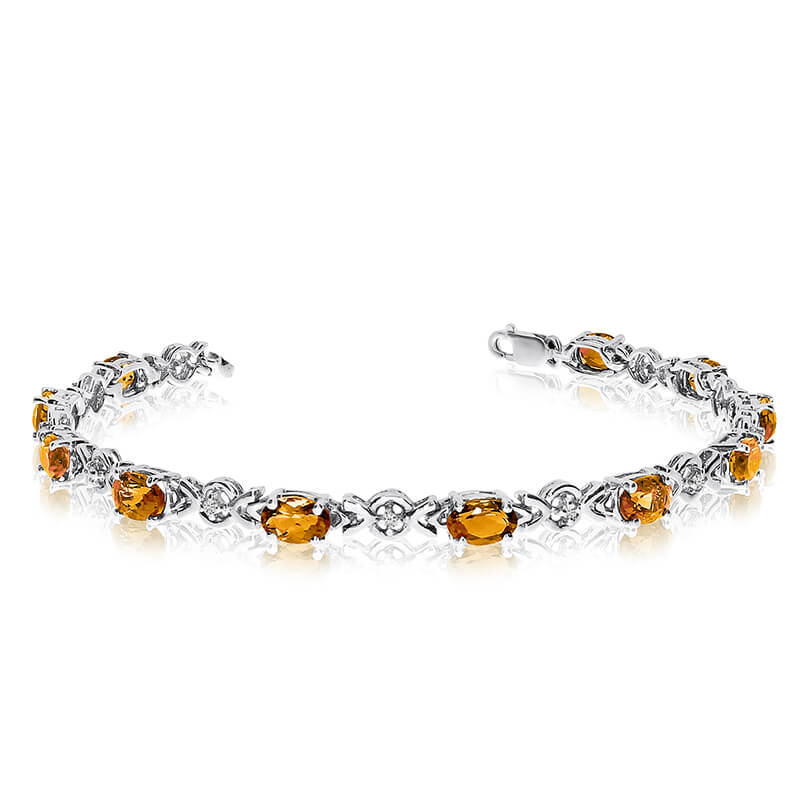 JCX3266: This 10k white gold oval citrine and diamond bracelet features eleven 6x4 mm stunning natural citrine stones with a 3.41 ct total gem weight.