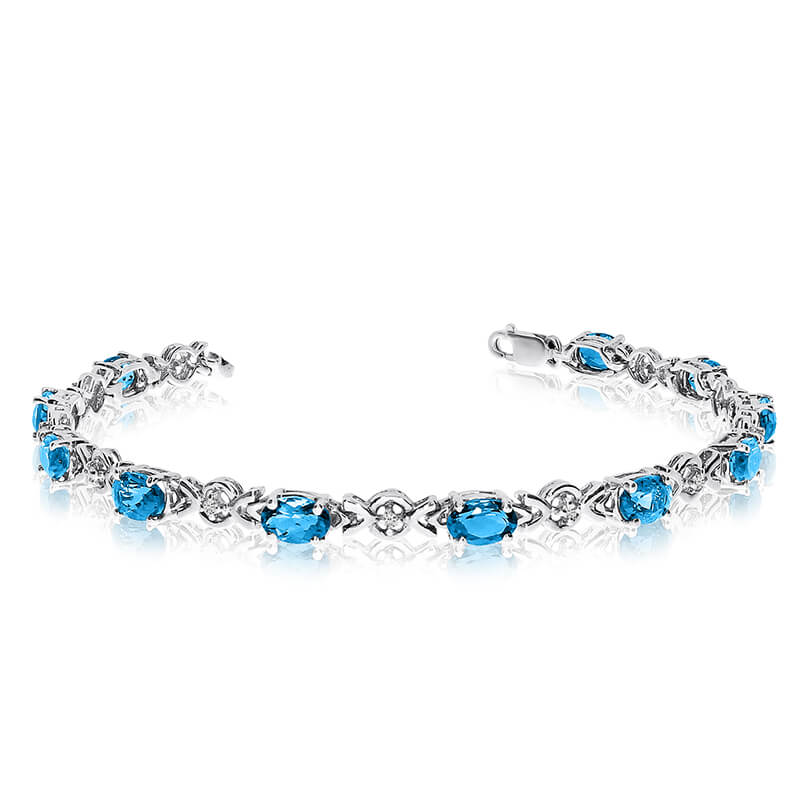 JCX3267: This 10k white gold oval blue topaz and diamond bracelet features eleven 6x4 mm stunning natural blue topaz stones with a 4.40 ct total gem weight.
