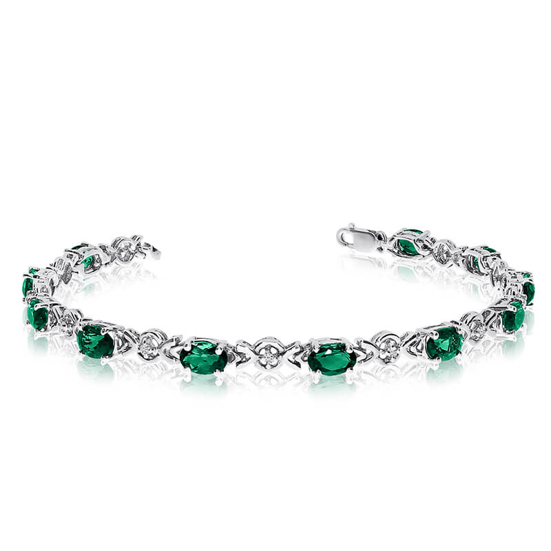 This 14k white gold oval emerald and diamond bracelet features eleven 6x4 mm stunning natural emerald stones with a 3.41 ct total gem weight.