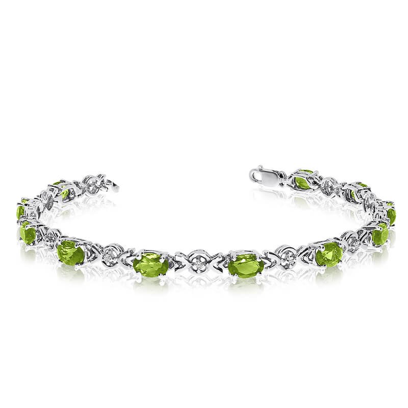 JCX3275: This 14k white gold oval peridot and diamond bracelet features eleven 6x4 mm stunning natural peridot stones with a 4.40 ct total gem weight.