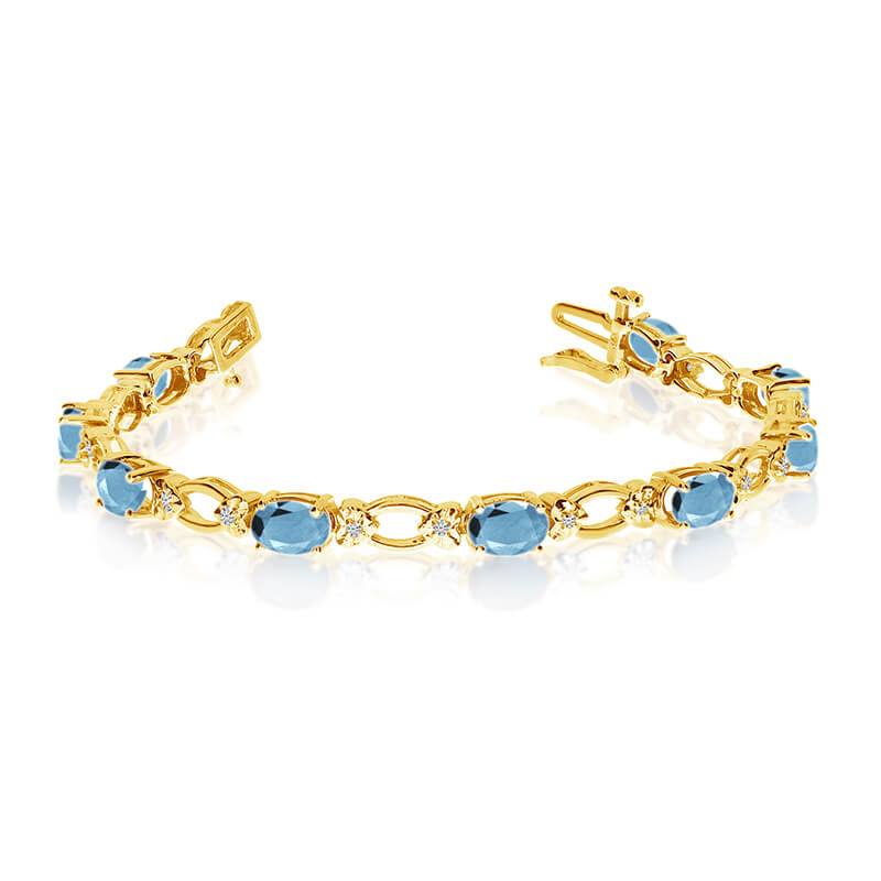 This 14k yellow gold natural aquamarine and diamond tennis bracelet features 12 oval aquamarines with a total gem weight of 3.48 carats and a total diamond weight of 0.12 carats.