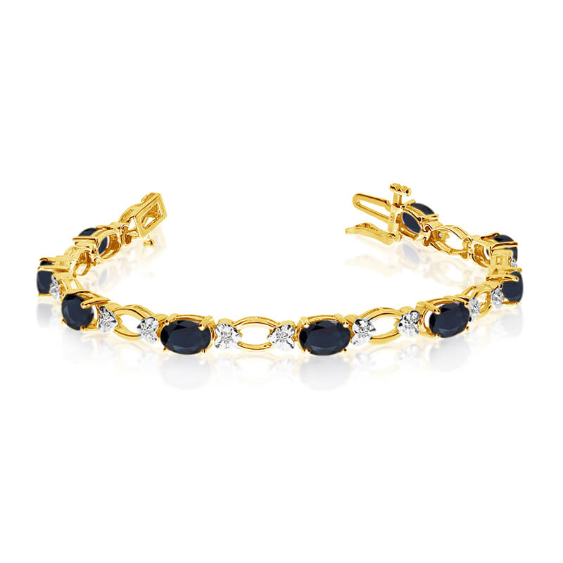 JCX3292: This 14k yellow gold natural sapphire and diamond tennis bracelet features 12 oval sapphires with a total gem weight of 4.68 carats and a total diamond weight of 0.12 carats.