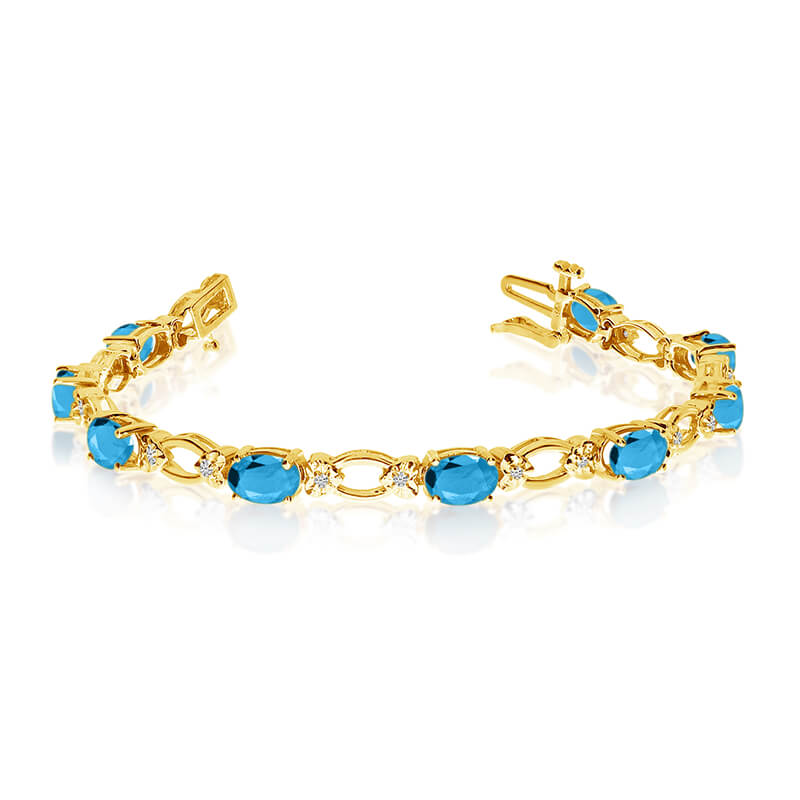 JCX3295: This 14k yellow gold natural blue-topaz and diamond tennis bracelet features 12 oval blue-topazs with a total gem weight of 4.8 carats and a total diamond weight of 0.12 carats.