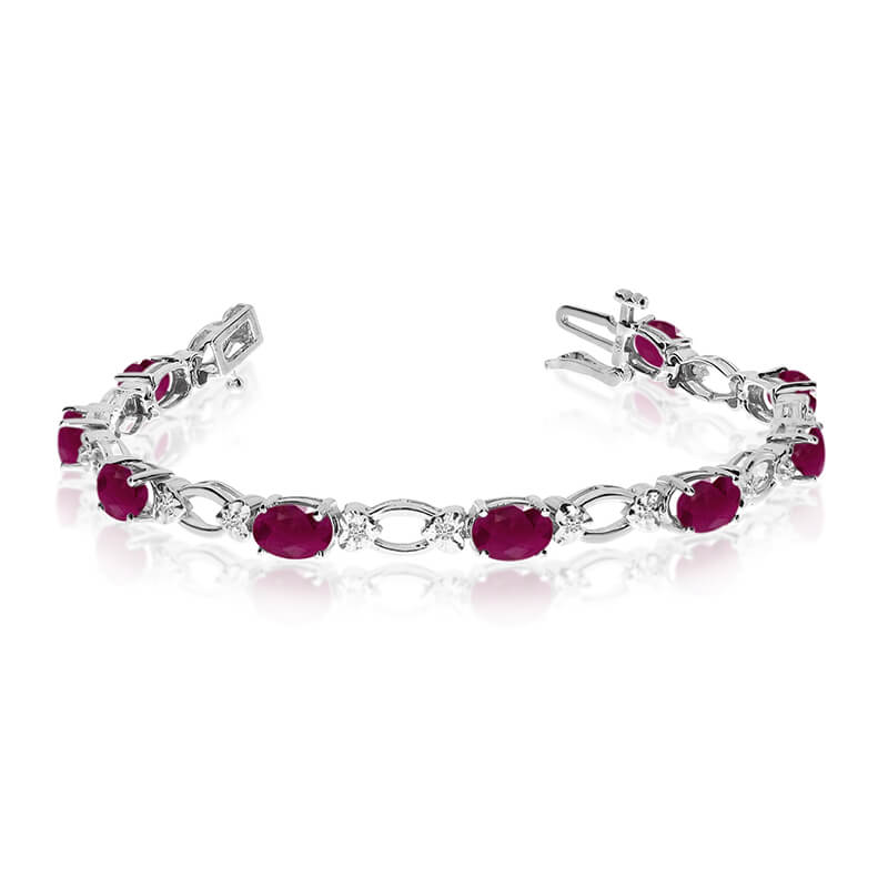 JCX3302: This 14k white gold natural ruby and diamond tennis bracelet features 12 oval rubys with a total gem weight of 4.32 carats and a total diamond weight of 0.12 carats.