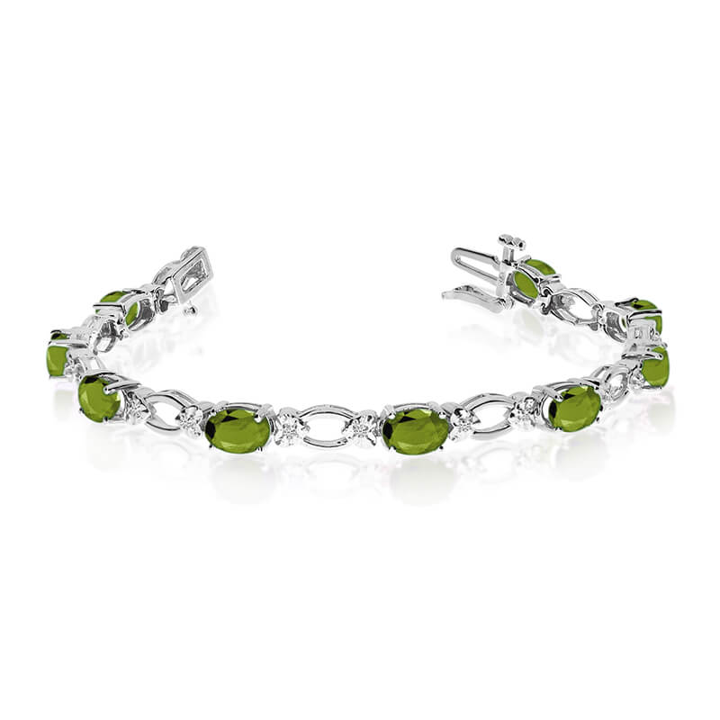 JCX3303: This 14k white gold natural peridot and diamond tennis bracelet features 12 oval peridots with a total gem weight of 4.8 carats and a total diamond weight of 0.12 carats.
