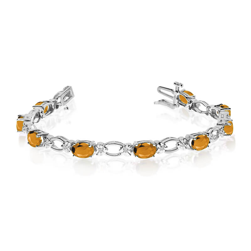 JCX3306: This 14k white gold natural citrine and diamond tennis bracelet features 12 oval citrines with a total gem weight of 3.72 carats and a total diamond weight of 0.12 carats.