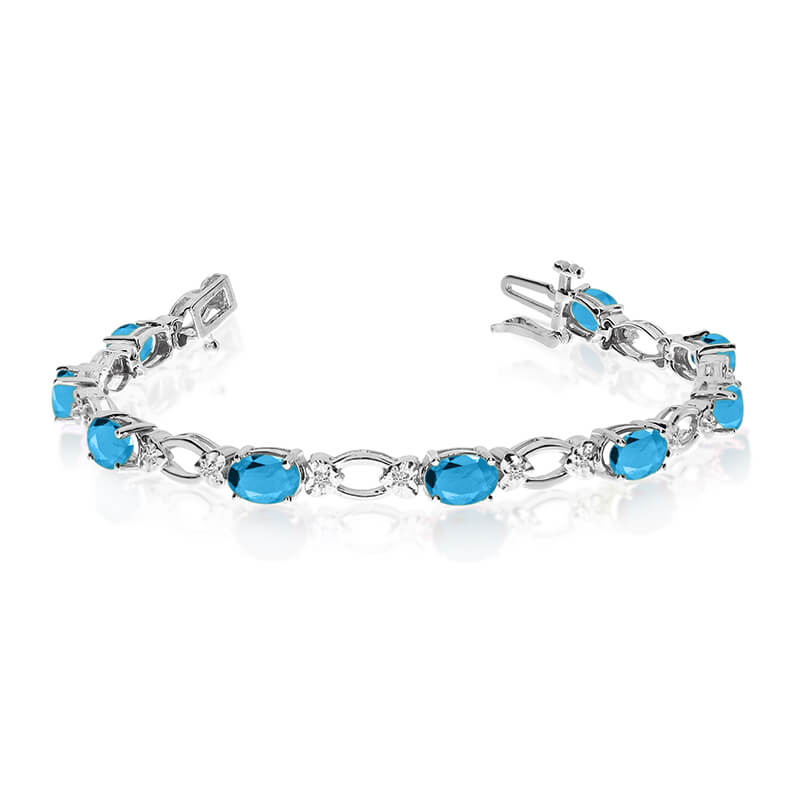 This 14k white gold natural blue-topaz and diamond tennis bracelet features 12 oval blue-topazs with a total gem weight of 4.8 carats and a total diamond weight of 0.12 carats.
