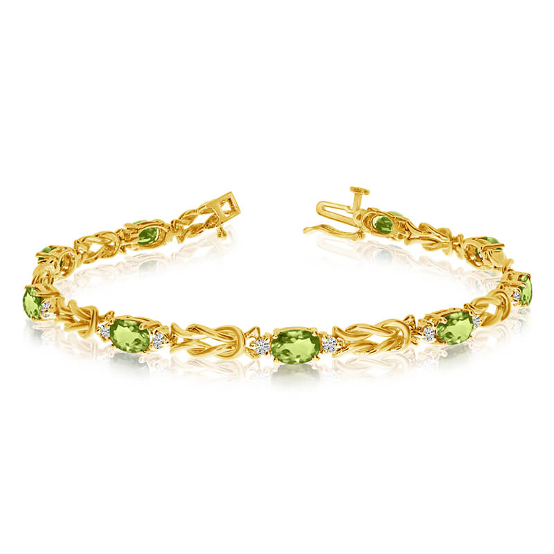 JCX3315: This 14k yellow gold natural peridot and diamond tennis bracelet features 9 oval peridots with a total gem weight of 3.6 carats and a total diamond weight of 0.5 carats.