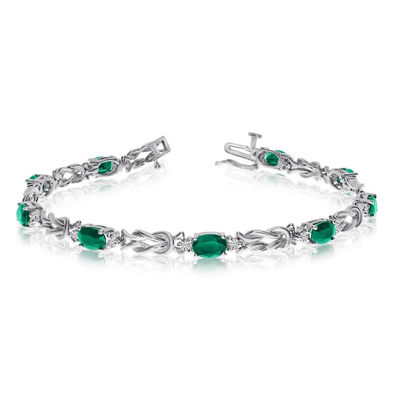 This 14k white gold natural emerald and diamond tennis bracelet features 9 oval emeralds with a total gem weight of 2.79 carats and a total diamond weight of 0.5 carats.