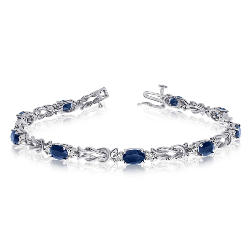 JCX3328: This 14k white gold natural sapphire and diamond tennis bracelet features 9 oval sapphires with a total gem weight of 3.51 carats and a total diamond weight of 0.5 carats.