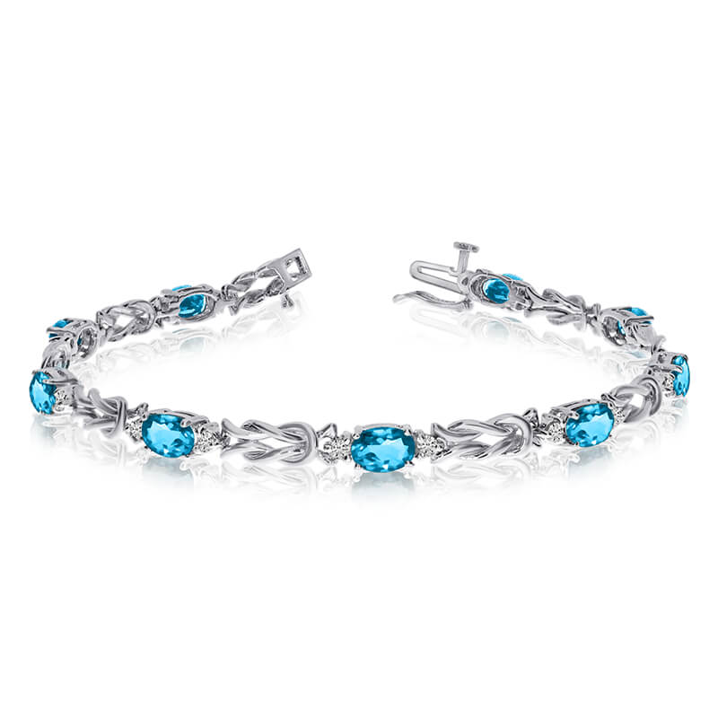 This 14k white gold natural blue-topaz and diamond tennis bracelet features 9 oval blue-topazs with a total gem weight of 3.6 carats and a total diamond weight of 0.5 carats.
