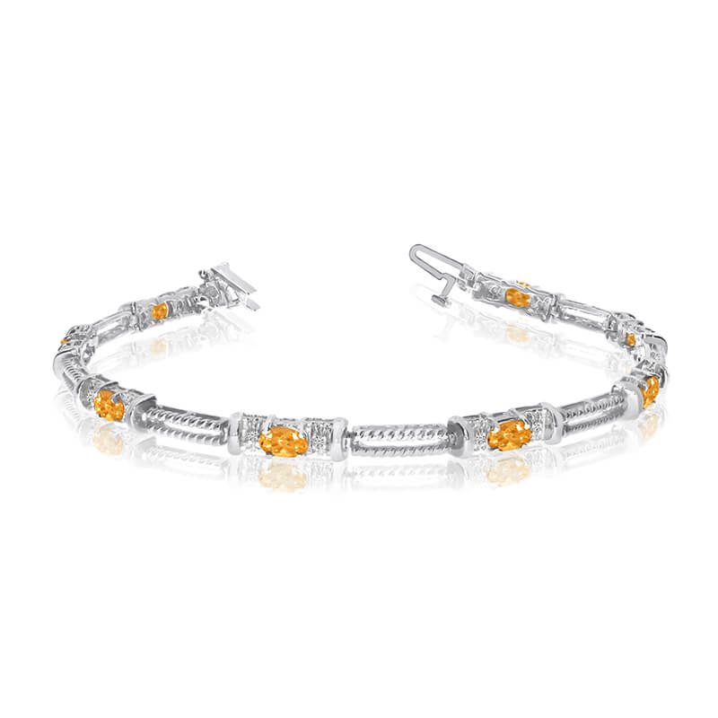 This 14k white gold natural citrine and diamond tennis bracelet features 8 oval citrines with a total gem weight of 1.2 carats and a total diamond weight of 0.16 carats.
