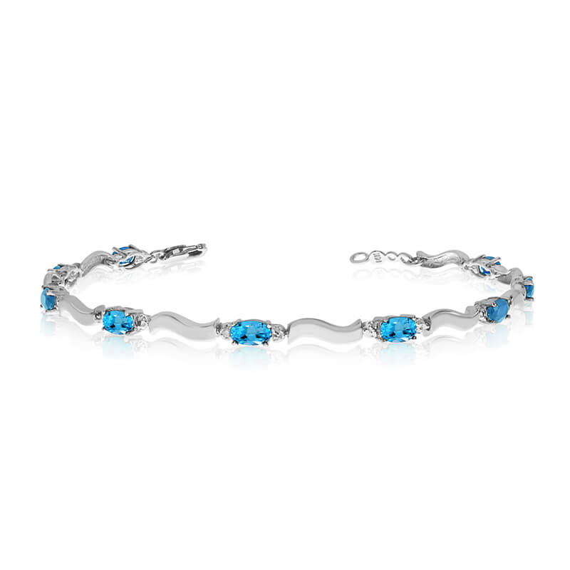 This 10K White Gold oval blue topaz and diamond bracelet features nine 5x3 mm stunning natural blue topaz stones with a 2.43 ct total gem weight.