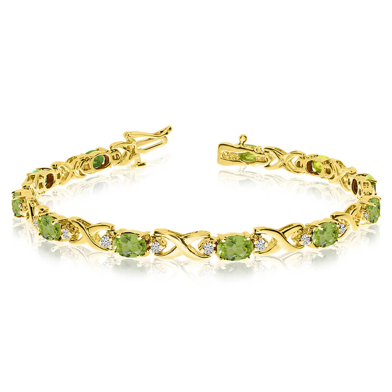 JCX3492: This 14k yellow gold natural peridot and diamond tennis bracelet features 11 oval peridots with a total gem weight of 4.4 carats and a total diamond weight of 0.4 carats.