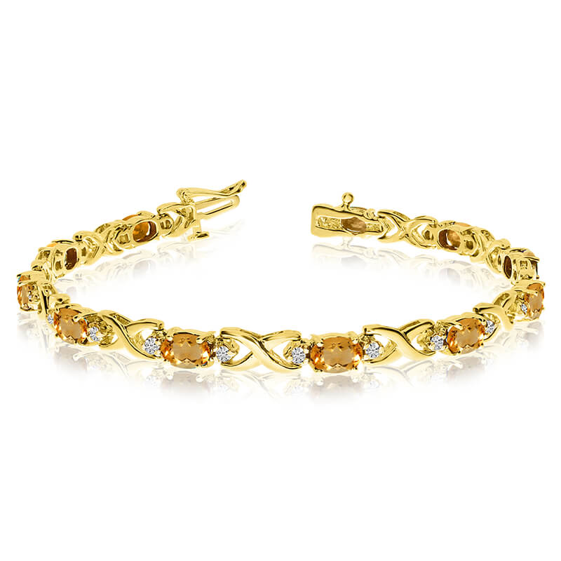 This 14k yellow gold natural citrine and diamond tennis bracelet features 11 oval citrines with a total gem weight of 3.41 carats and a total diamond weight of 0.4 carats.