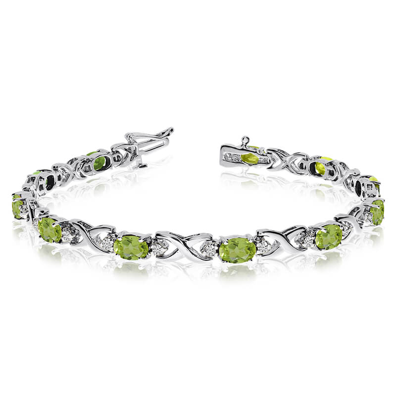 JCX3504: This 14k white gold natural peridot and diamond tennis bracelet features 11 oval peridots with a total gem weight of 4.4 carats and a total diamond weight of 0.4 carats.