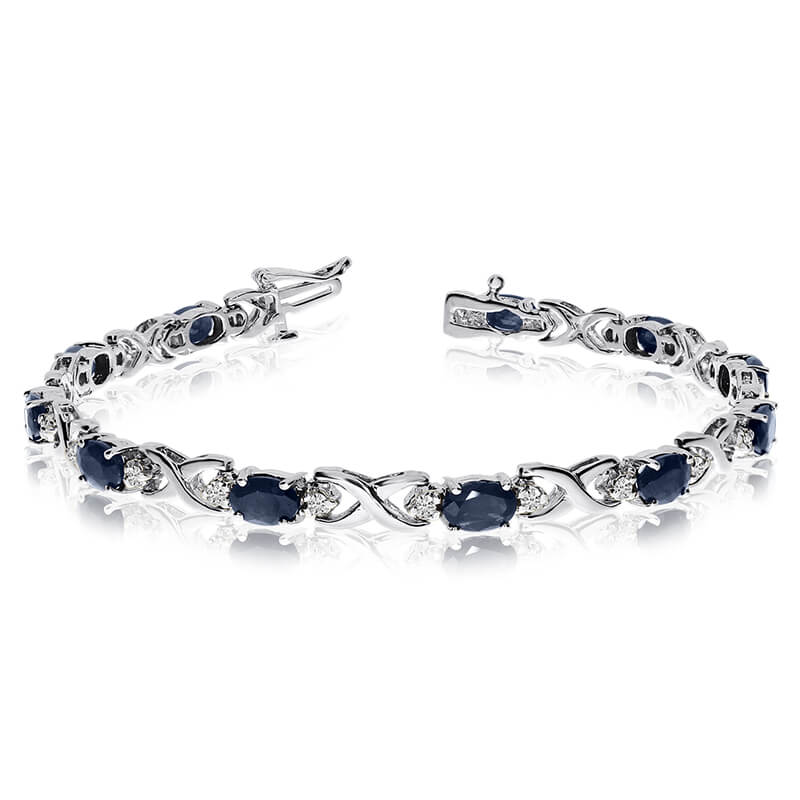 JCX3505: This 14k white gold natural sapphire and diamond tennis bracelet features 11 oval sapphires with a total gem weight of 4.29 carats and a total diamond weight of 0.4 carats.