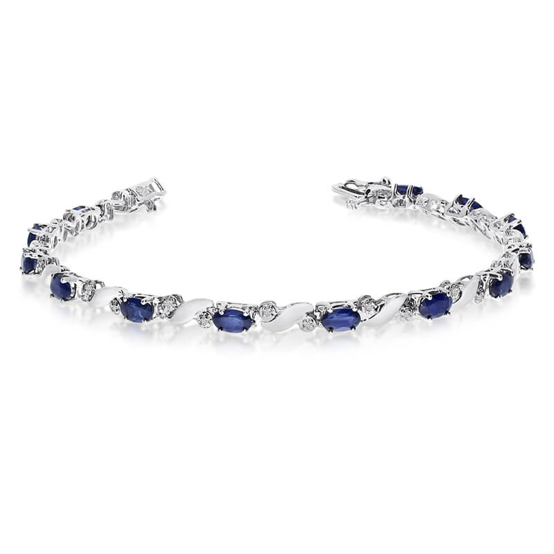 This 14k white gold natural sapphire and diamond tennis bracelet features 13 oval sapphires with a total gem weight of 3.25 carats and a total diamond weight of 0.15 carats.