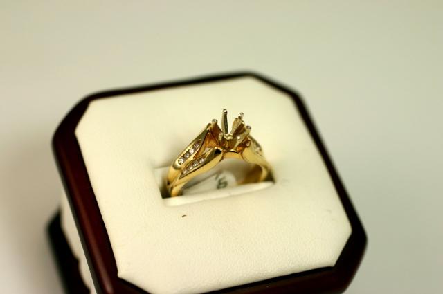 14K yellow gold semi-mount ring holding 16 round side diamonds, adding up to .24ct total weight o...