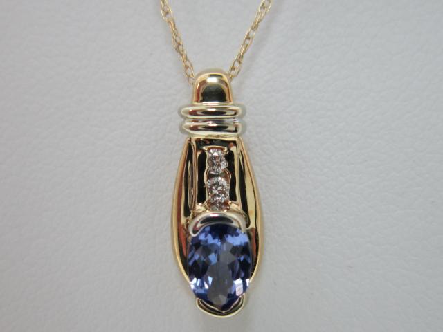 JCSJCS1025: This 14kt yellow gold pendant, with only a splash of white gold, contains a gem quality Tanzanite gemstone accented by two diamonds. Made in Ohio! STOP IN TO SEE THE NEW PRICE
