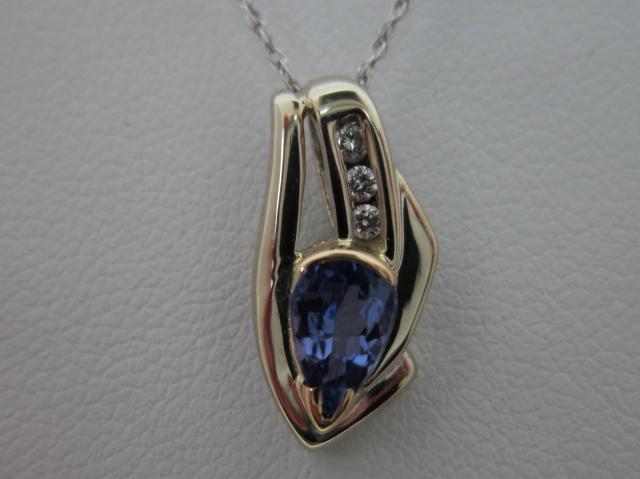 JCSJCS1026: This 14kt white gold pendant, with only a splash of yellow gold,  contains a gem quality Tanzanite gemstone accented by three diamonds. Made in Ohio! STOP IN TO SEE THE NEW PRICE