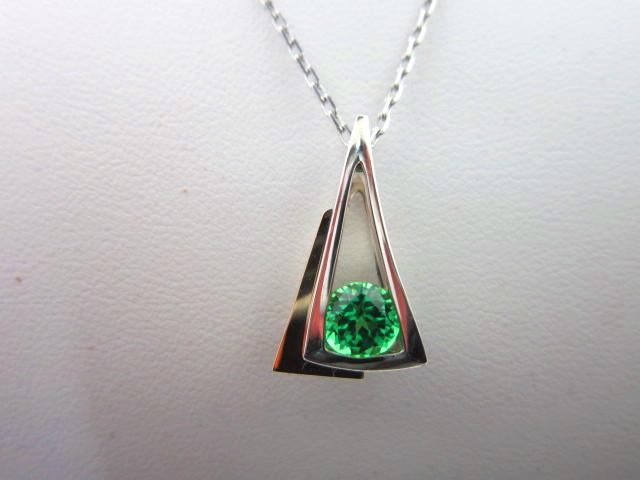 JCSJCS1370: From the Strellman Design Studio in Oregon we bring you a contemporary pendant set with a large created Tsavorite Garnet. Set in sterling, accented in 14kt yellow gold. SOLD