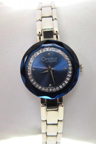 JCSJCS1394: This Caravelle fashion watch by Bulova contains a circle of simulated diamonds on a blue dial along with a faceted crystal. SOLD