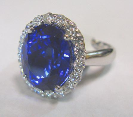 JCSA898: Beautiful tanzanite and diamond ring in 18kt white gold.  Oval 9.67ct. (approx. 13 X 11mm&#39;s) tanzanite is surrounded by 18 round diamonds totalling .90cts.  All stones are prong set in an 18kt. white gold mounting, ring by Spark.